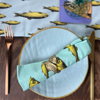 Sardine napkin lying across a plate