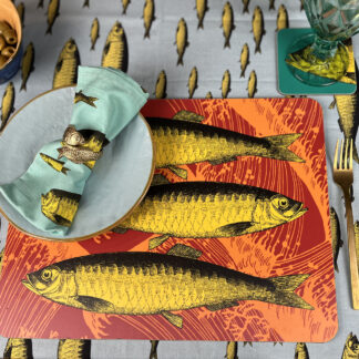 Orange and yellow Sardine table mat on fish tablecloth